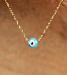 Evil eye necklace - blue evil eye - gold evil eye necklace - a little blue glass evil eye on a 14k gold vermeil chain This super cute little blue and white glass evil eye hangs from a 16 inch 14k gold vermeil chain. Please feel free to select a different length chain if you prefer! Also available in sterling silver. The evil eye is worn to protect against bad spirits and negative energies. This little eye measures approximately 5mm. More from BubuRuby? https://www.etsy.com/shop/BubuRuby?ref=hdr_ Gold Evil Eye Necklace, Bad Spirits, Evil Eye Necklace Gold, Blue Evil Eye, Necklace Blue, Evil Eye Necklace, Dream Jewelry, Eye Necklace, Diy Necklace