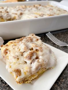 a white plate topped with food next to a casserole dish