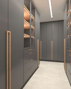 an empty walk - in closet with lots of shelves and drawers on the walls,