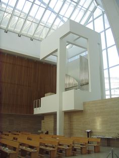 the inside of a building with wooden benches