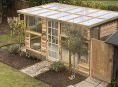 a small wooden house with a glass roof