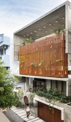 a person walking up the stairs in front of a building with wooden slats on it