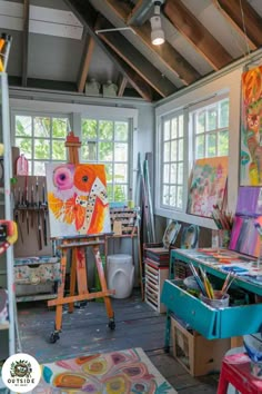 an artist's studio with lots of art work on easels and canvases