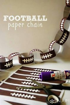 football paper chain with scissors, glue and tape next to it on top of a table