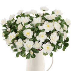 a white vase filled with lots of white flowers