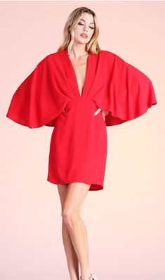 Whether you're going to a wedding, gala, shower or Holiday party, this amazing cape dress will be sure to wow the crowd! This dress features a gathered, tuck-pleat v neckline, cape design on the shouldersback and a mini length. Pair with strappy heels and a clutch for an elegant, timeless look. Chic Draped V-neck Evening Dress, Flowy Pre-draped Party Dress, Spring V-neck Dresses With Structured Shoulders, Pre-draped Cape Evening Dress, Spring Formal Dress With Cape Sleeves, Flutter Sleeve Dresses For Gala, Formal V-neck Mini Dress With Draped Sleeves, Formal Mini Dress With Draped Sleeves And V-neck, Cocktail Evening Dress With Cape Sleeves