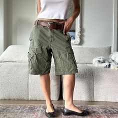 Vintage y2k khaki green cargo shorts low rise short cargo pocket shorts. Model is 32D/26 waist/5ft. Measures 34 inches waist by 11 inches inseam. Tagged size 32W. Y2k Khaki Bottoms With Cargo Pockets, Y2k Cargo Style Khaki Bottoms, Y2k Khaki Cargo Bottoms, Y2k Style Khaki Cargo Bottoms, Y2k Green Cargo Style Bottoms, Green Y2k Style Cargo Bottoms, Y2k Shorts With Pockets, Utility Bermuda Shorts With Cargo Style, Y2k Green Cargo Bottoms