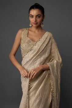 Gold pre-draped and textured saree with gold toned accents. Paired with a blouse with geometric hand embroidery. - Aza Fashions Gold Pre-draped Saree For Party, Gold Pre-draped Saree With Zari Work, Elegant Draped Cutdana Blouse Piece, Elegant Draped Blouse Piece With Cutdana, Raw Silk Pre-draped Saree For Reception, Festive Raw Silk Draped Saree, Festive Draped Raw Silk Saree, Elegant Cutdana Pre-draped Saree, Gold Festive Draped Saree