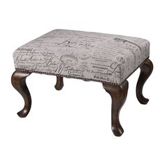 an ottoman with wooden legs and a patterned upholstered cushion on the top, against a white background