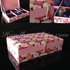 an open pink box sitting on top of a black table next to a mirror and other items