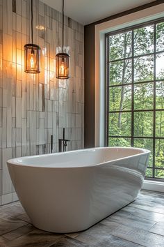 a large white bath tub sitting in a bathroom next to a window with two lights on it