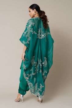 Sea green organza gathered kite style cape with mirror, swarovski, metallic sequins, studs and pearls hand embroidery. Comes with a satin strappy jumpsuit. - Aza Fashions Party Kaftan With Mirror Work For Festivals, Festive Silk Kaftan With Sequins, Festive Silk Kaftan With Cape Sleeves, Festive Embellished Dress With Kimono Sleeves, Silk Embellished Kaftan For Parties, Silk Bollywood Kaftan For Party, Green Mirror Work Evening Sets, Evening Green Sets With Mirror Work, Silk Kaftan With Sequins For Party