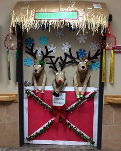 some reindeers are standing in front of a bulletin board