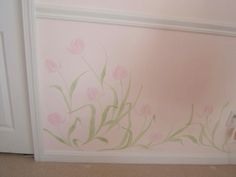 a pink wall with flowers painted on it