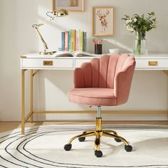 a pink chair sits in front of a desk with books on it and a white rug