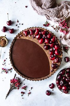 a chocolate tart with cherries on top