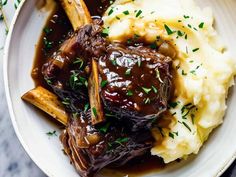 a white bowl filled with mashed potatoes and beef