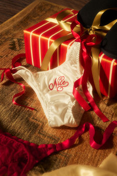 Our Flirty & Wordy Bikini Panty Pack comes with one satin panty embroidered with "Nice" and one sheer tulle panty embroidered with "Naughty."

Color: White & Red Satin Panty, Christmas Dreaming, Winter Essentials, Satin Ribbon, Red White, Red And White