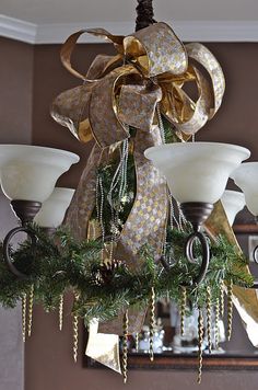 a chandelier hanging from the ceiling in a room with lights and decorations on it