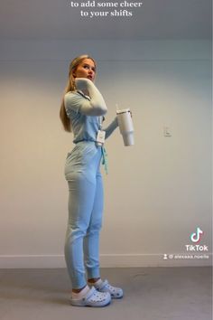 a woman holding a coffee cup in her right hand and looking up at the sky