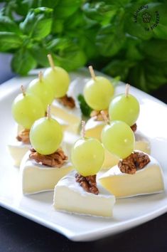 grapes and cheese are arranged on a plate