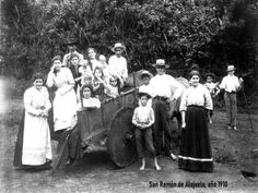 an old black and white photo of people standing around a wagon