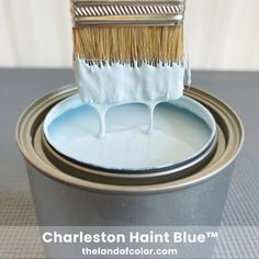 a paint can with a brush in it and the words charleston haight blue on top