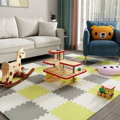 a child's play room with toys on the floor and couches in the background