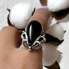 Handmade ring in high-quality sterling silver with natural obsidian stone. The band has adjustable size, pear shape stone in black silver shine color.  If you are looking for jewelry that is handmade, unique, and not mass-produced, you are in the right place. We also can make matching earrings, pendants, and bracelets. Just write to me for more details. More from us For more obsidian rings, click here: https://etsy.me/3BTYZ5O For more gemstone rings, click here: https://etsy.me/3LtrVVh For more Black Teardrop Rings For Gift, Black Teardrop Ring For Gift, Obsidian Rings, Adjustable Bohemian Obsidian Jewelry, Elegant Hand-strung Onyx Jewelry, Black Obsidian Crystal Ring, Unique Black Obsidian Jewelry, Black Gemstone Ring, Pear Shape Ring