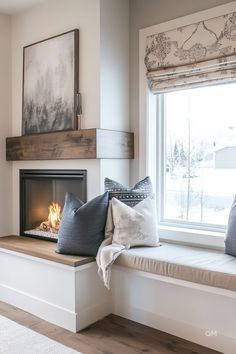 a window seat with pillows and a fire place