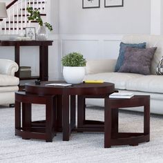 a living room filled with furniture and a stair case in the back drop off table