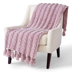 a white chair with a pink blanket on it