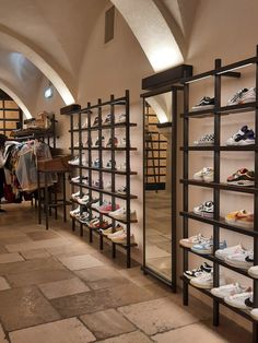 there are many pairs of shoes on display in the store's shoe rack area