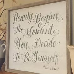 a sign that says beauty begins the moment you decide to be yourself on a shelf