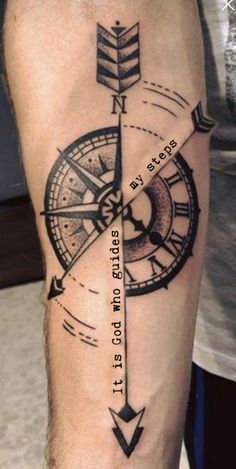 a man's arm with a compass tattoo on it and an arrow in the middle