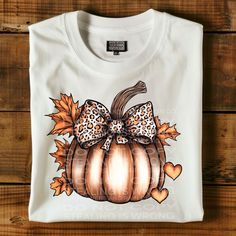 a white t - shirt with an image of a leopard print pumpkin on it