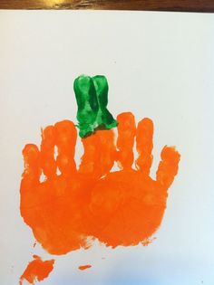 an orange handprint with a green bow on it