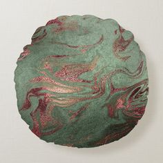 a green and pink decorative pillow on a white wall