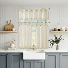 a kitchen with blue cabinets and white counter tops