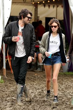 a man and woman walking in the mud