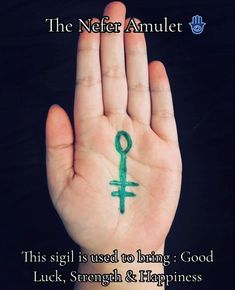 a person's hand with a green tattoo on it and the words, the nefer anubet