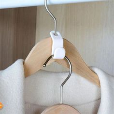 a wooden coat hanger attached to a white jacket