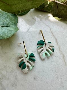 Handmade polymer clay earrings Variegated monstera leaf earrings Approx 2" length Leaf charm is 1" Gold plated posts Nickel free ** $3 flat rate canada wide shipping sent oversized letter mail, no tracking or insurance.  Upgrade to registered mail with tracking and $100 insurance for $10. I'm not responsible for undelivered or lost mail** Monstera Leaf Earrings, Variegated Monstera, Handmade Clay, Leaf Charms, Mail Letters, Monstera Leaf, Christmas Earrings, Moon Earrings, Handmade Polymer Clay