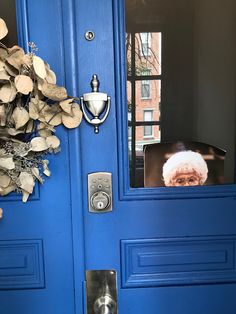 a blue door with a person's face on the screen