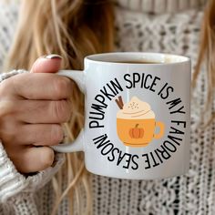 a woman is holding a coffee mug in her hands with the words pumpkin spice is my favorite beverage