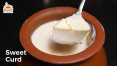 a bowl filled with cream sitting on top of a table