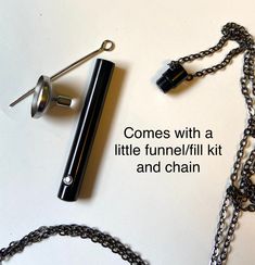 the contents of a necklace and chain with words written on it that read comes with a little funnel / fill kit and chain