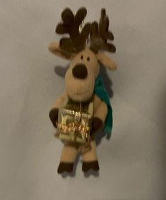 a stuffed animal with a gold belt around it's neck and antlers on its head