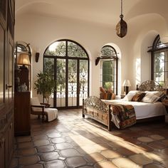 a large bedroom with arched windows and stone flooring, along with a king size bed