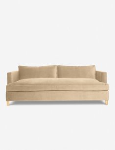 a beige couch with two pillows on the back and one arm folded out to show it's fabric